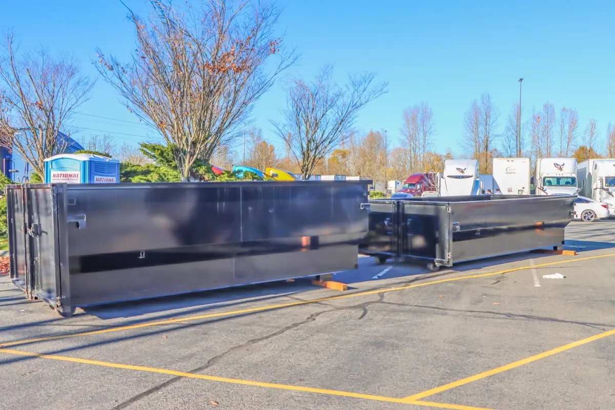 Professional dumpster rental service with roll-off container on residential driveway in Scriba